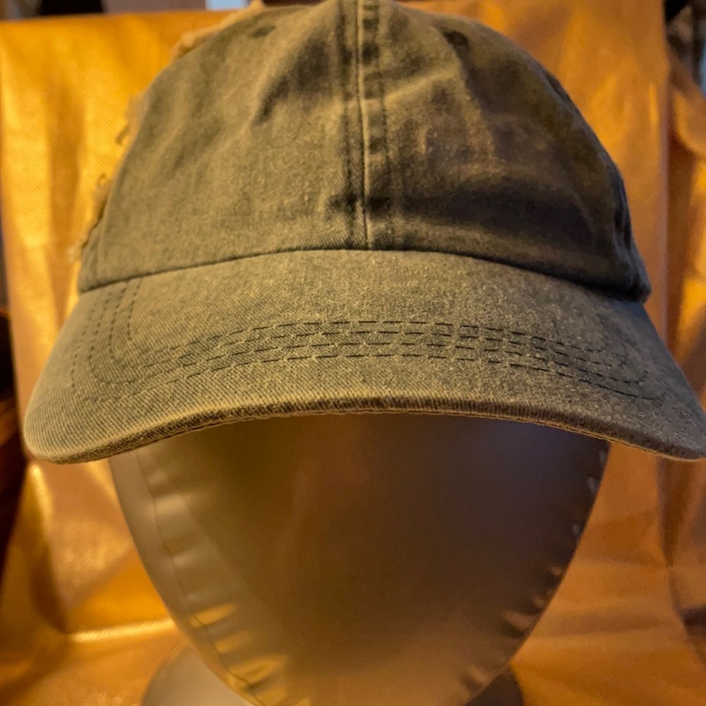 Distressed jean cap with cross stitched on it